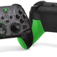 A picture of Microsoft's 20th Anniversary Xbox Wireless Controller, which has translucent black plastic in front and neon green hand grips.